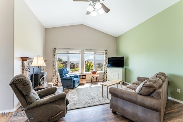 living room featuring lofted ceiling, ceiling fan, and dark hardwood / wood-style floors