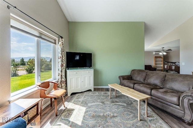 living room featuring hardwood / wood-style floors, ceiling fan, and lofted ceiling