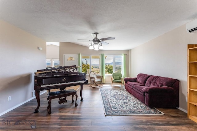 interior space with a wall mounted air conditioner, vaulted ceiling, dark hardwood / wood-style floors, ceiling fan, and a textured ceiling