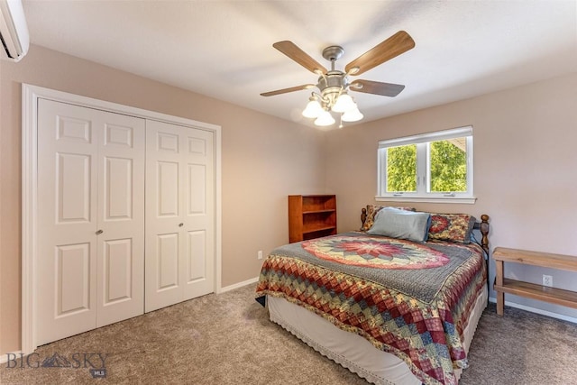 carpeted bedroom with a wall mounted AC, a closet, and ceiling fan