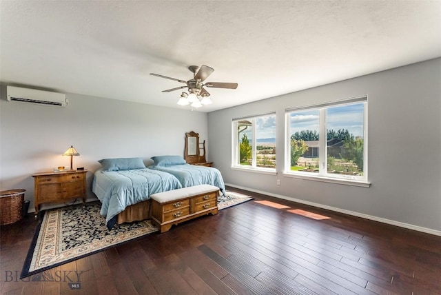 bedroom featuring ceiling fan, dark hardwood / wood-style flooring, and a wall mounted AC