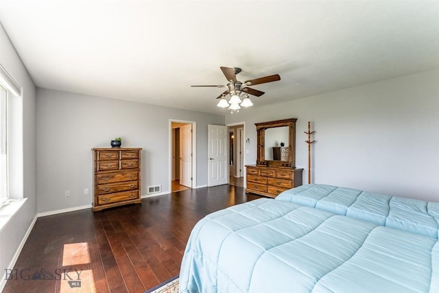 bedroom with multiple windows, dark hardwood / wood-style floors, and ceiling fan