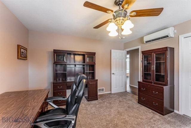 carpeted office space featuring a wall unit AC and ceiling fan