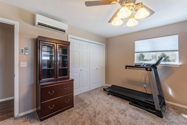 workout area featuring a wall mounted air conditioner and light carpet