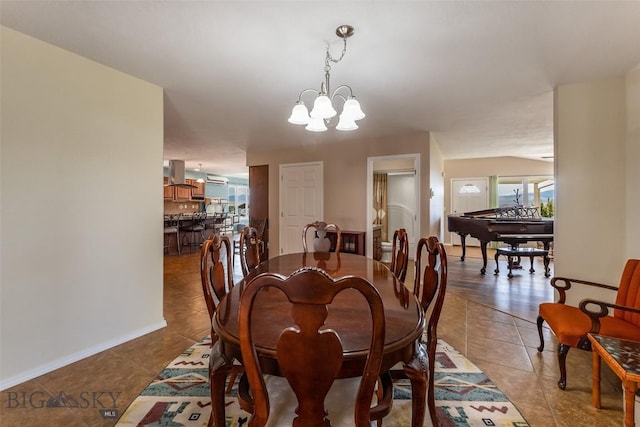 tiled dining room featuring a notable chandelier