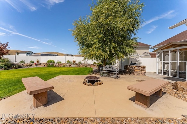 view of patio with area for grilling and an outdoor fire pit