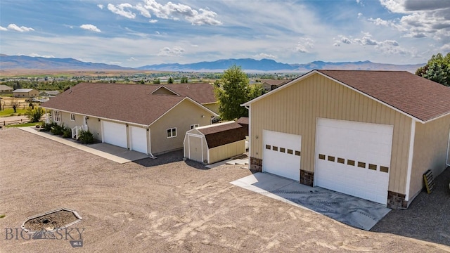 exterior space featuring a mountain view and an outdoor structure