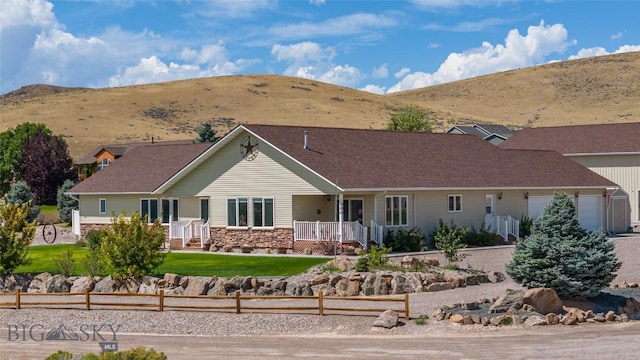 ranch-style home with a mountain view and a garage