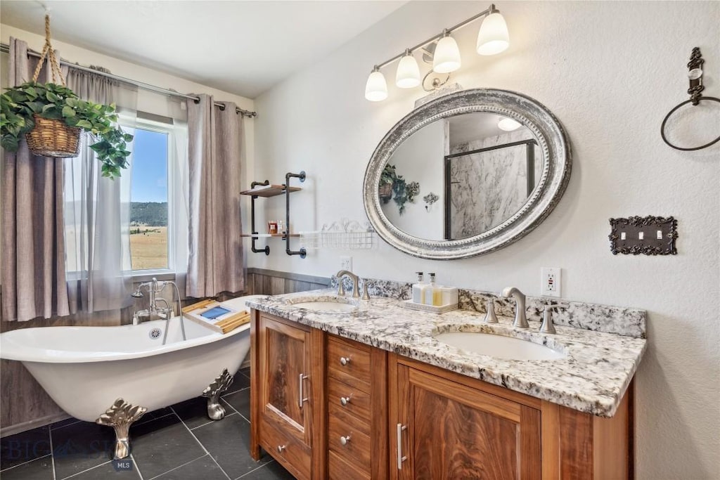 bathroom featuring vanity, tile patterned floors, and a tub