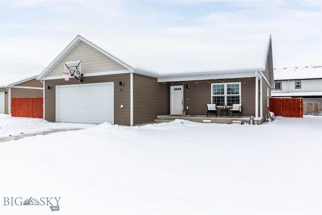 single story home with a porch and a garage