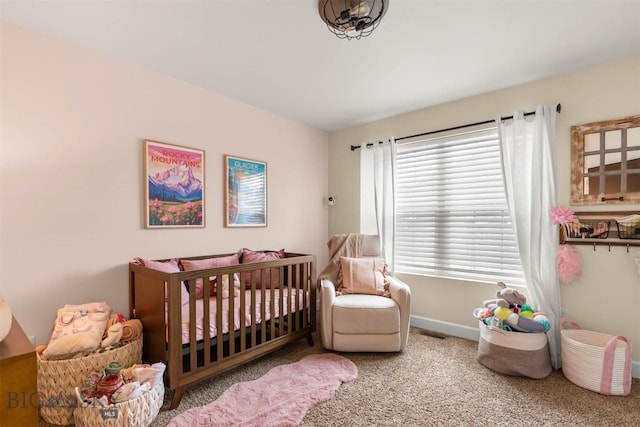 carpeted bedroom with a nursery area