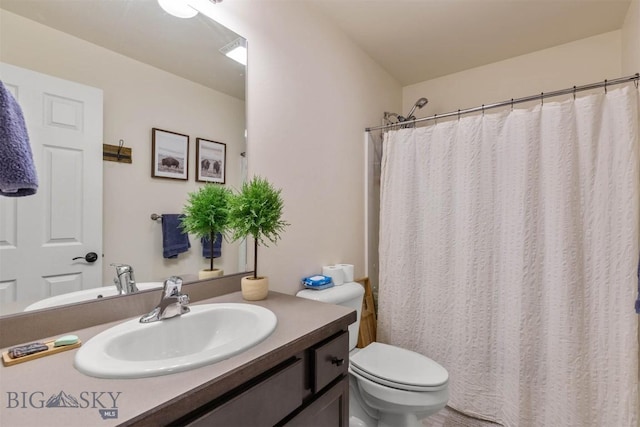 bathroom featuring walk in shower, vanity, and toilet