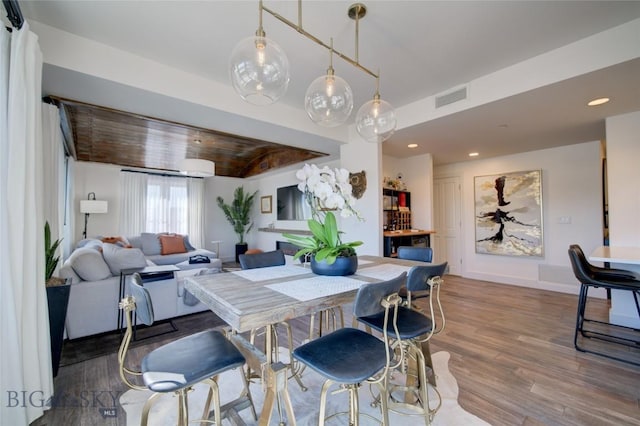 dining room featuring wood-type flooring and wood ceiling