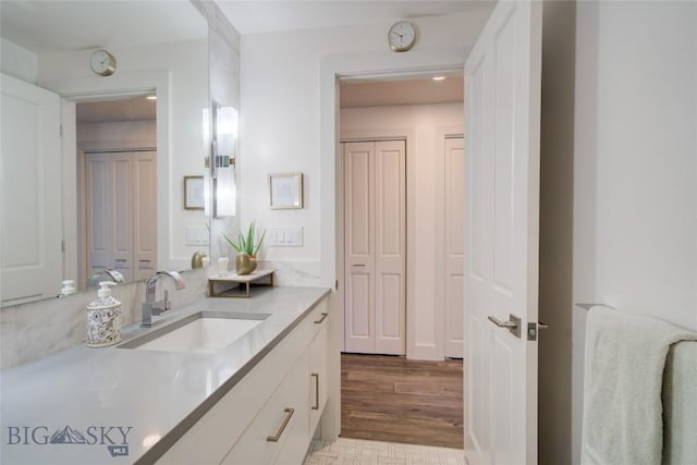 bathroom with vanity and hardwood / wood-style flooring