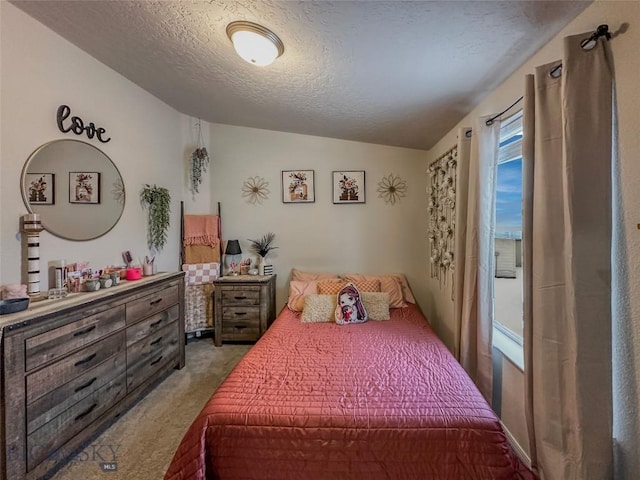 bedroom with lofted ceiling, light colored carpet, and a textured ceiling