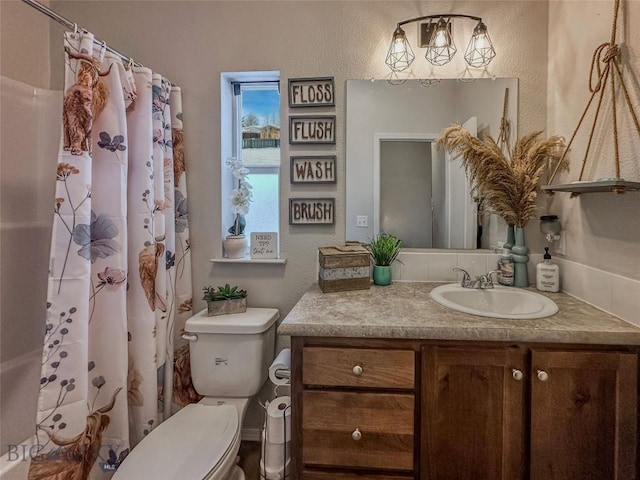 bathroom with walk in shower, vanity, and toilet