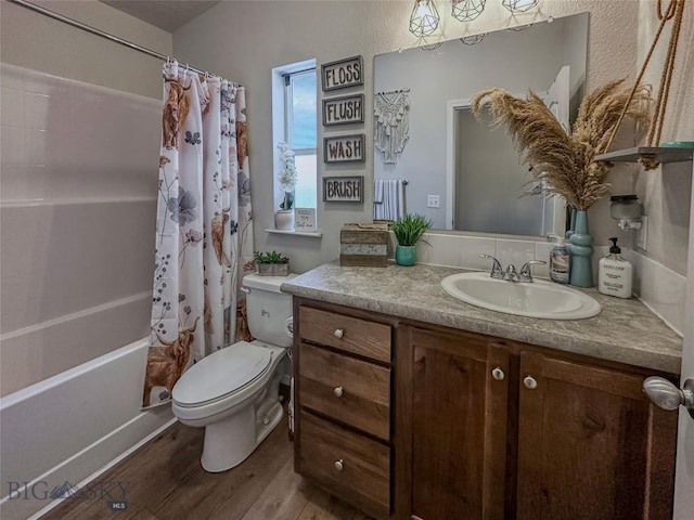 full bathroom with vanity, hardwood / wood-style floors, shower / bathtub combination with curtain, and toilet