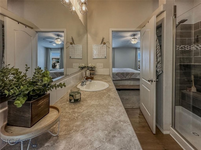 bathroom with vanity, hardwood / wood-style flooring, a chandelier, and walk in shower