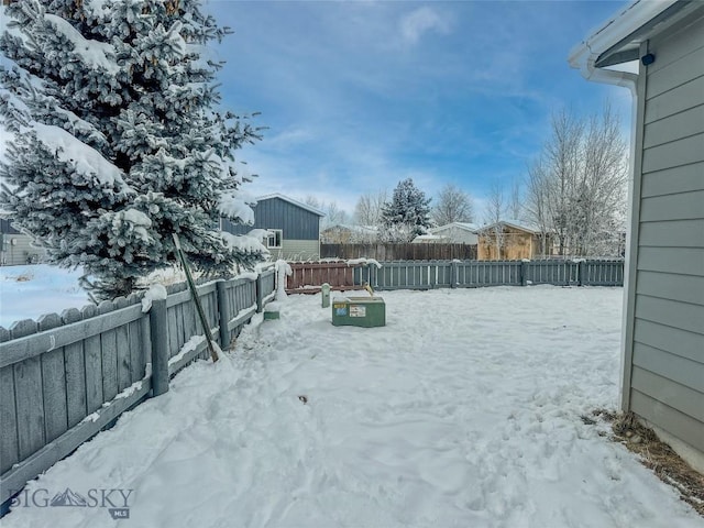 view of yard layered in snow