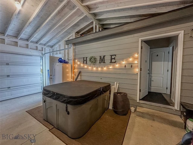 garage featuring wood walls