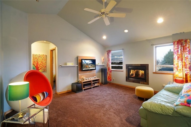 living room with ceiling fan, carpet floors, and high vaulted ceiling