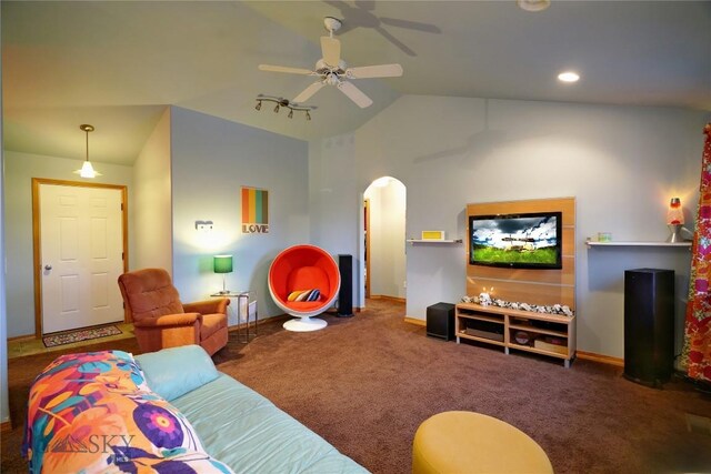 carpeted living room featuring ceiling fan, rail lighting, and vaulted ceiling