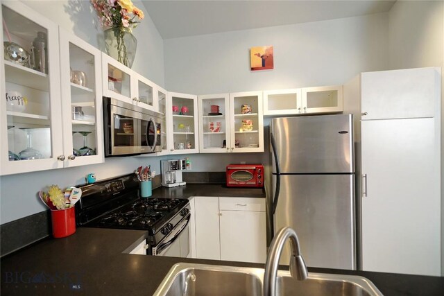 kitchen featuring white cabinets, sink, and stainless steel appliances