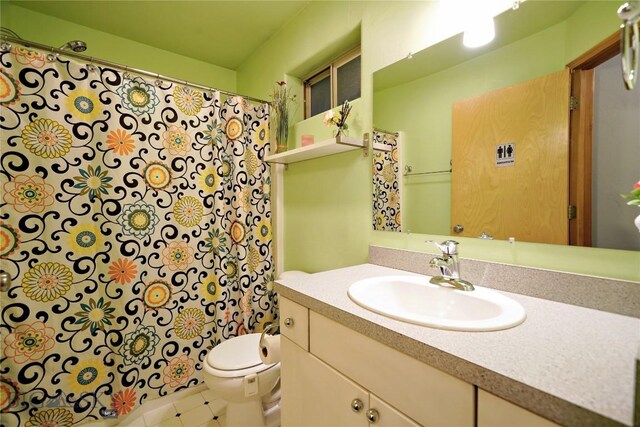 bathroom featuring tile patterned flooring, vanity, and toilet