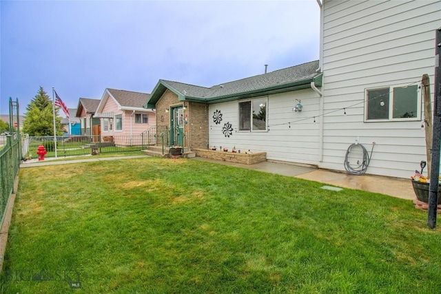 back of house with a lawn