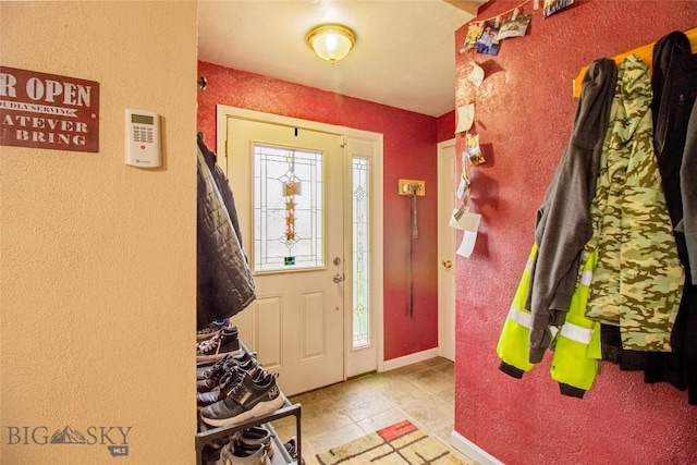 foyer entrance with light tile patterned floors