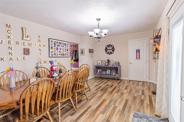 dining area with a notable chandelier and wood-type flooring