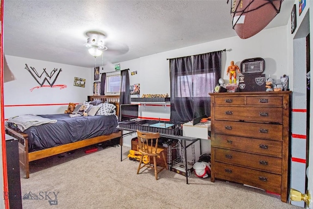 bedroom with ceiling fan, light colored carpet, and a textured ceiling