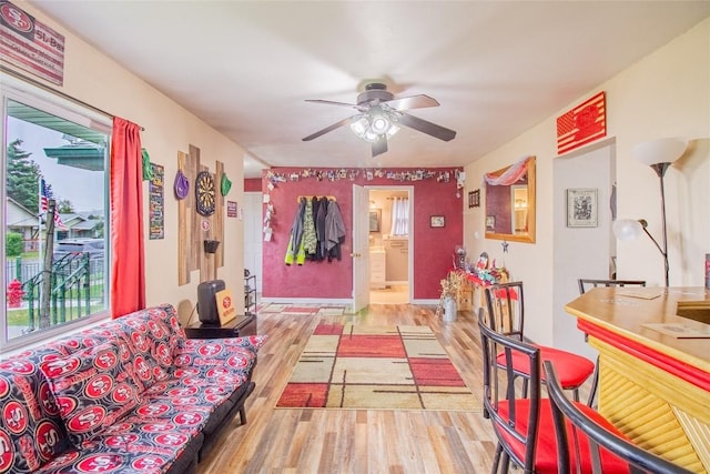 living room with ceiling fan and light hardwood / wood-style floors