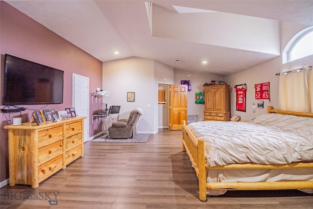 bedroom featuring hardwood / wood-style flooring and vaulted ceiling