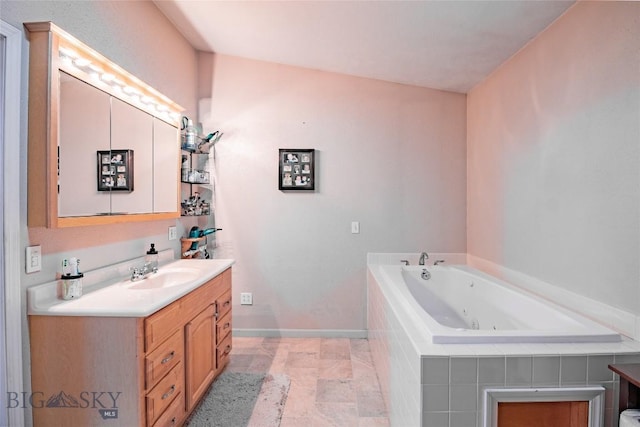 bathroom with vanity and tiled bath