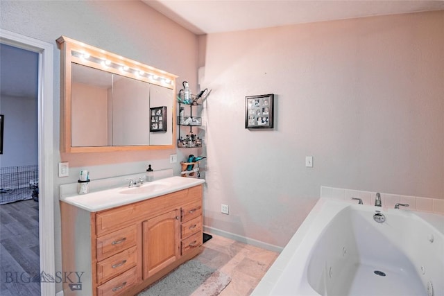 bathroom with a bathing tub and vanity