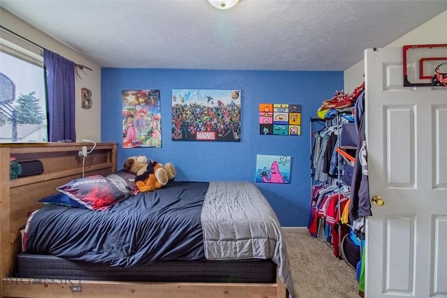 bedroom featuring carpet and a textured ceiling