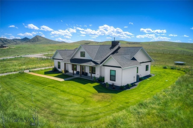 exterior space featuring a mountain view and a front yard