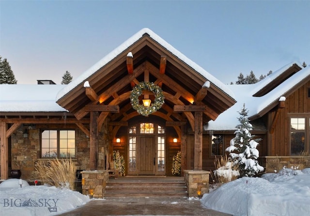 view of snow covered property entrance