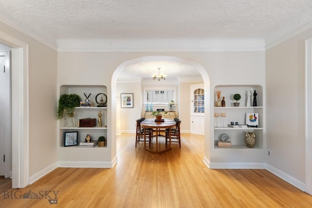 dining space with crown molding and a textured ceiling