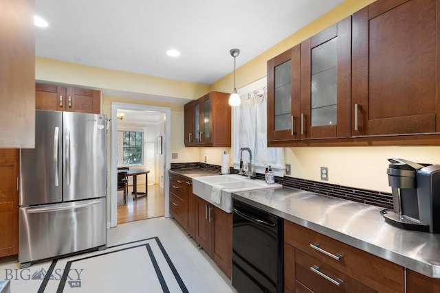 kitchen with dishwasher, hanging light fixtures, sink, stainless steel counters, and stainless steel refrigerator