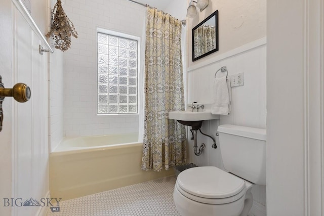 bathroom with shower / bath combo, toilet, and tile patterned floors