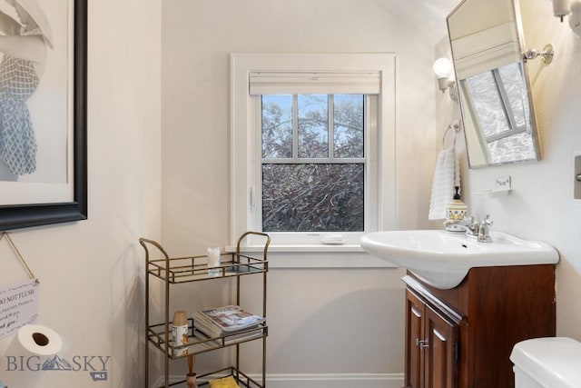 bathroom featuring vanity and toilet