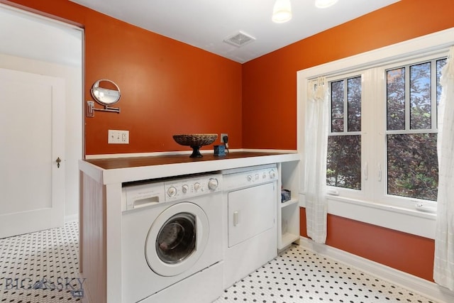 clothes washing area featuring independent washer and dryer