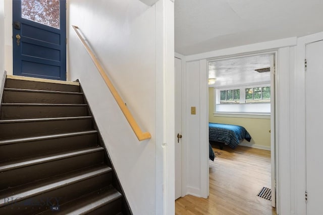 stairs with wood-type flooring