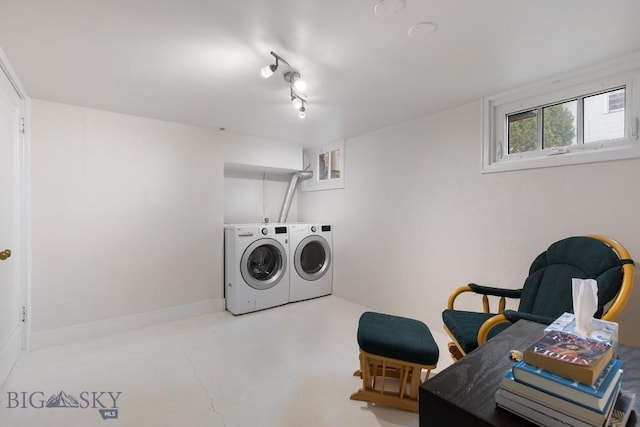 clothes washing area featuring independent washer and dryer