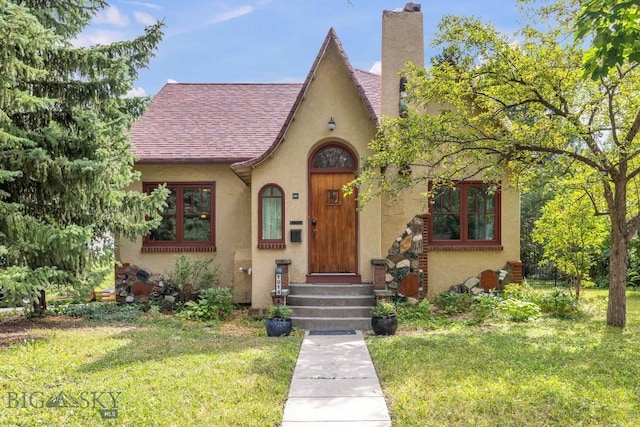 english style home with a front yard