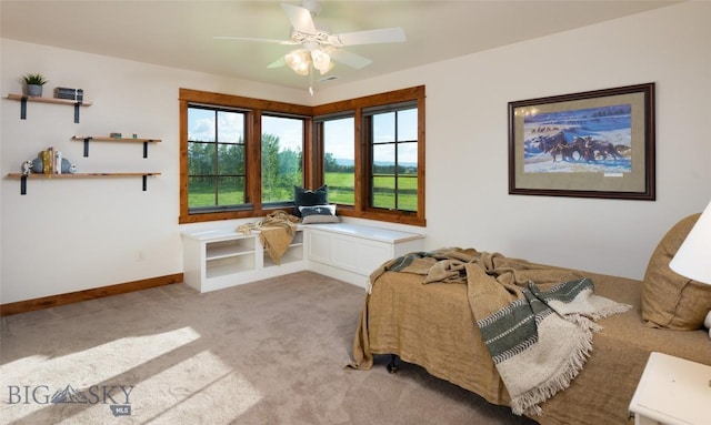 bedroom featuring a ceiling fan, light carpet, and baseboards