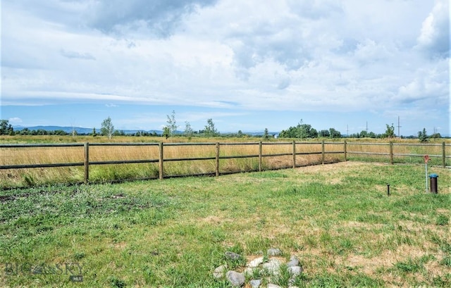 view of yard featuring a rural view and fence