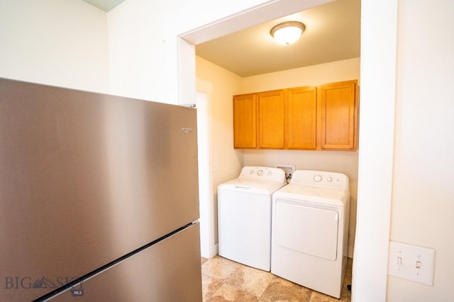 laundry area with cabinet space and separate washer and dryer